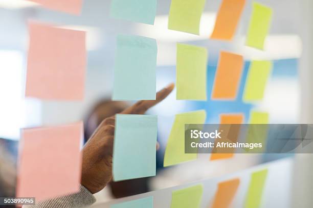 Close Up Of A Businessman Pointing At A Sticky Note Stock Photo - Download Image Now