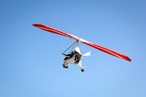 istock Motorized hang glider soaring in the blue sky 503891096