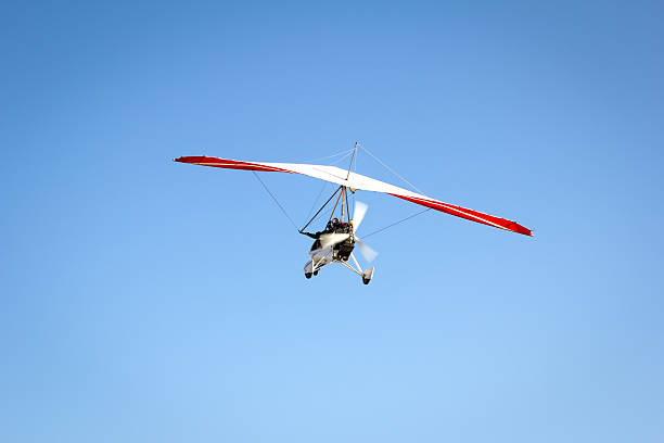 istock Motorized hang glider soaring in the blue sky 503891116