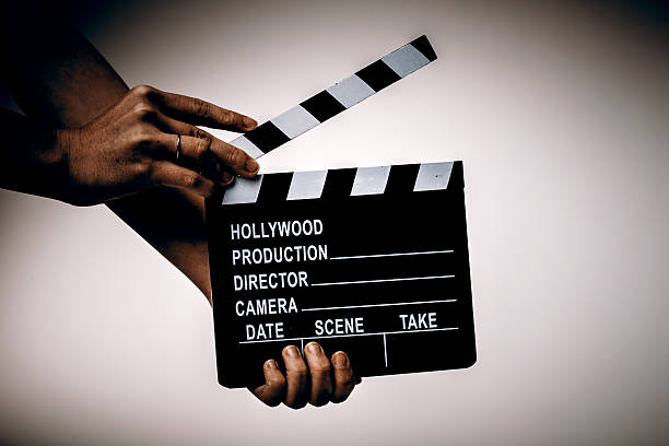 istock Movie flapper in womans hands on white background 503891436