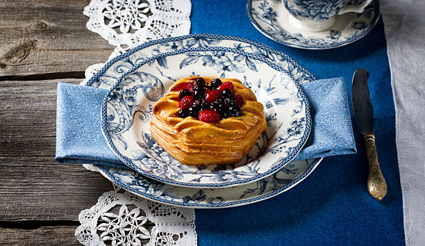 istock Danish with wild berries on blue and white plates 503891968