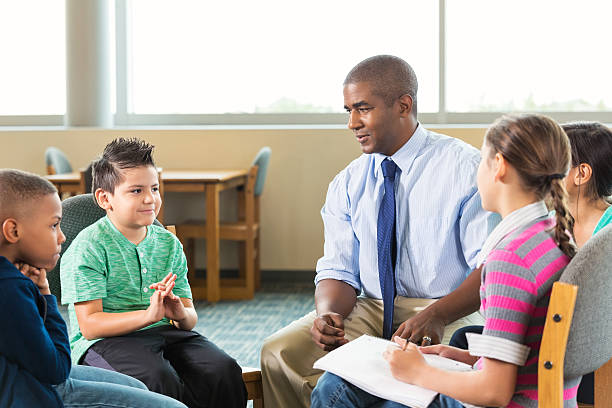 istock Diverse elementary students meeting with counselor after school 503893084