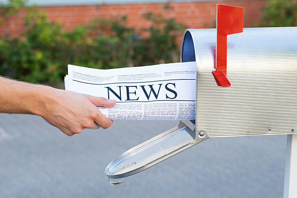 istock Person Hands Opening Mailbox To Remove Newspaper 503898100