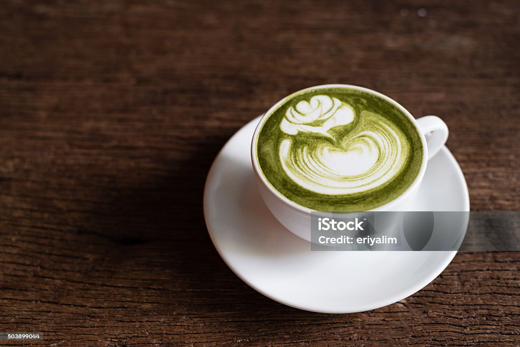 matcha green tea latte with latte art in rose pattern Cafe Stock Photo