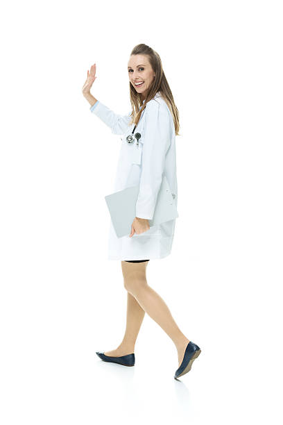 istock Smiling woman waving hand and walking 503911218