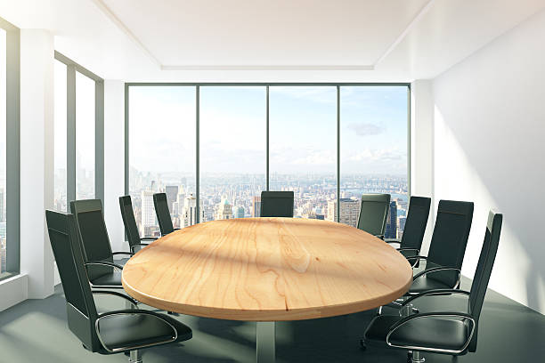 istock Sunny conference room with oval table, chairs and city view 503911954