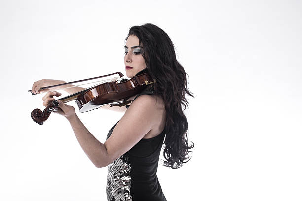 istock Young beautiful woman playing the violin over white background 503912702