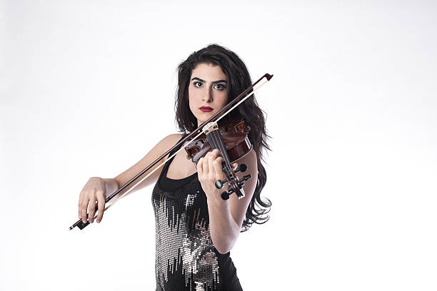 istock Young beautiful woman playing the violin over white background 503912848