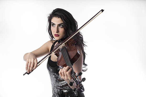istock Young beautiful woman playing the violin over white background 503913150