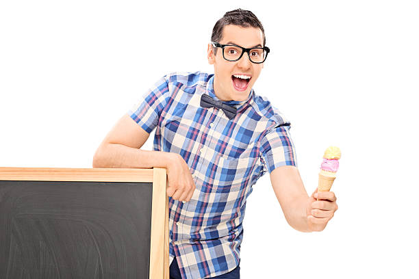 istock Man holding an ice cream behind a blackboard 503914729