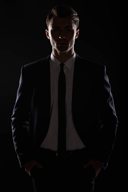 istock Handsome business man in black suite, backlight 503915149
