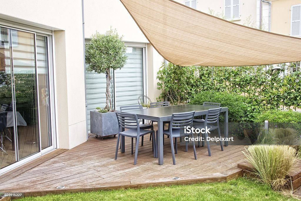 Modern terrace with dining table and chairs Patio Stock Photo