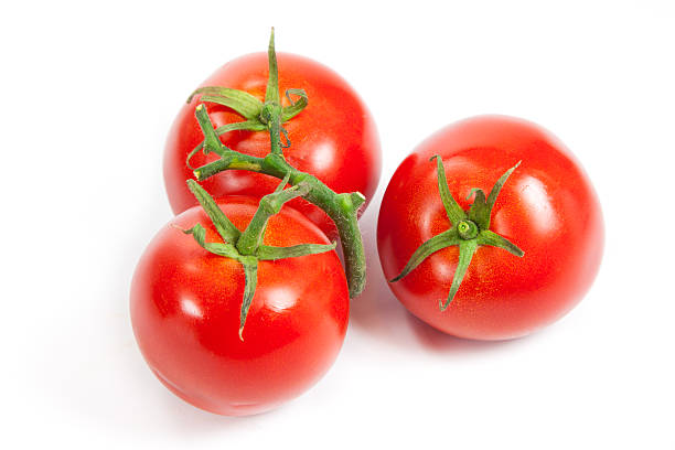 istock three fresh tomatoes with green leaves isolated on white backgro 503915633
