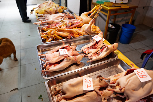 Prepared guinea pigs on tray in Peruvian street market