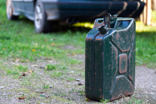 Old Jerrycan in foreground and a Car in background