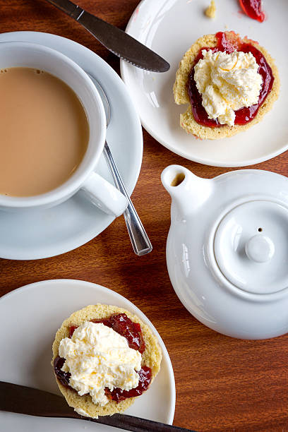 Afternoon tea Traditional English afternoon tea of scones with clotted cream and jam, along with a cup of hot tea. scone photos stock pictures, royalty-free photos & images