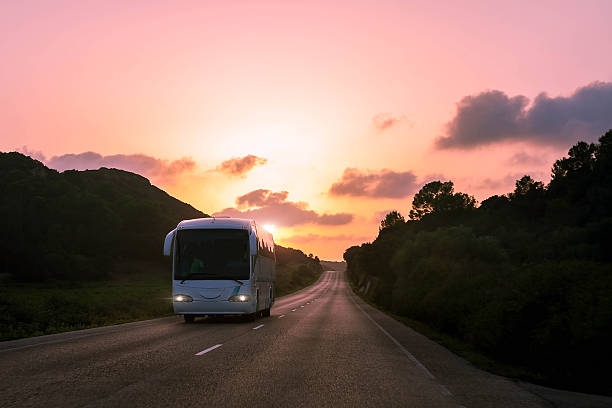 istock White bus on the sunset road 503917402