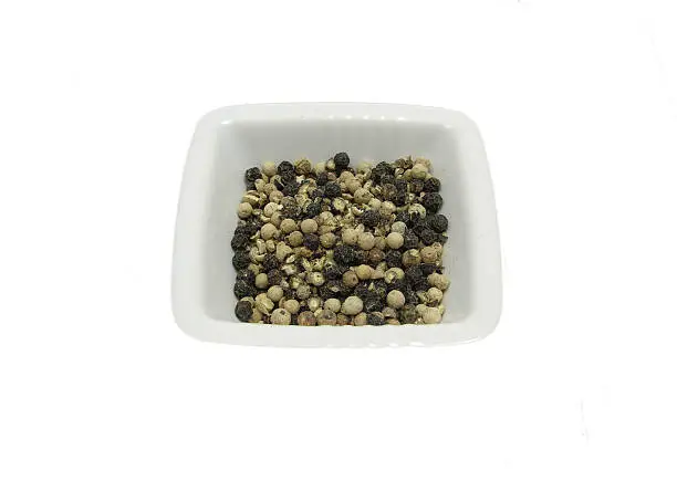 Isolated white bowl of chinaware with pepper corns