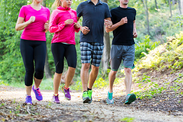 istock Group of runners jogging through woods in a park 503920217