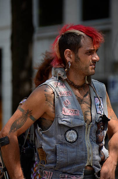 Punk style Barcelona, Spain - July 16, 2013: Punk style man with red hair walking down the street while wearing jeans top and a rat on his shoulder  emo hair guys stock pictures, royalty-free photos & images