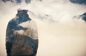 Double Exposure of Man and Cloudy Mountains