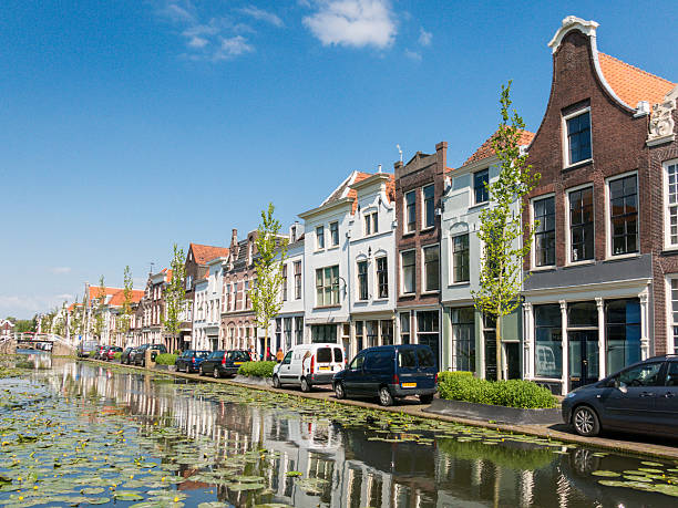 Canal view in Gouda, Holland Gouda, Netherlands - June 10, 2015: Facades of old houses on Turfmarkt canal in Gouda, Netherlands gouda south holland stock pictures, royalty-free photos & images