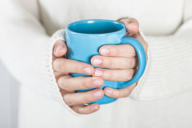 istock Cup of tea or coffee in female hands 503924112
