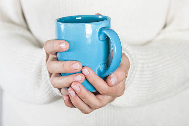 istock Cup of tea or coffee in female hands 503924550