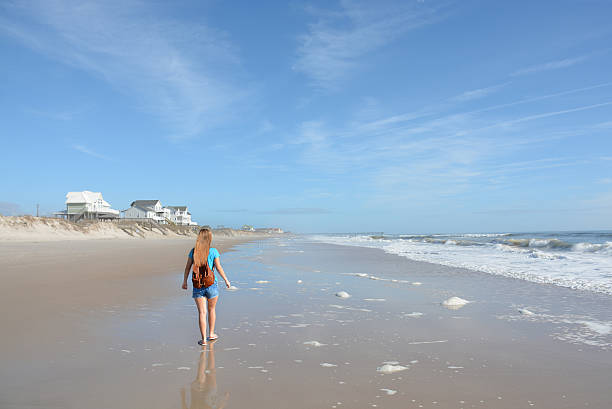 istock Girl hiking on the beach. 503925082