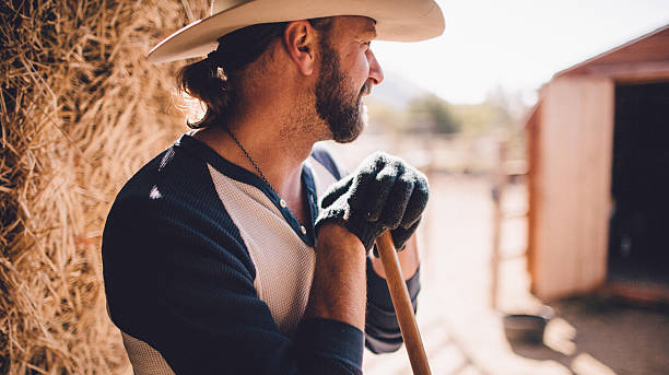 istock Cowboy takes break from manual labor to rest 503943577