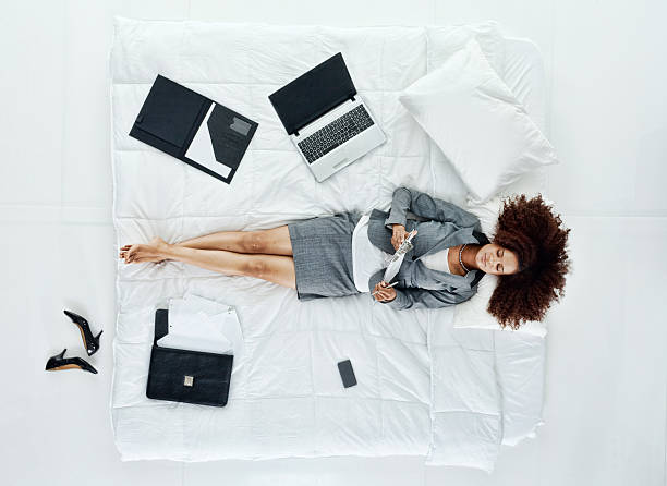 istock Businesswoman lying in bed while holding a clipboard 503944203
