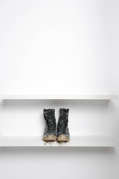 istock muddy army boots on white shelf 503946795