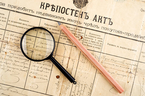 istock old deed property, magnifying glass and pencil, selective focus 503946947