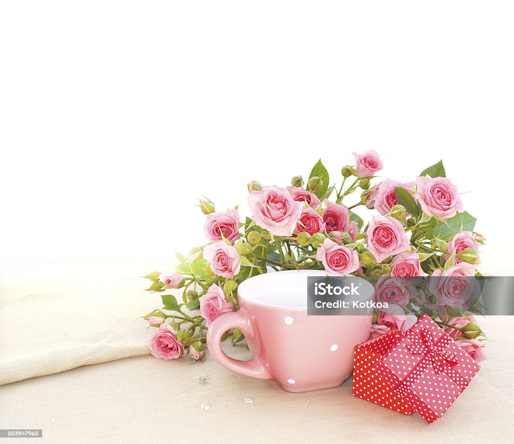 Gift box and roses. Red box with red ribbon gift and red roses. Birthday Stock Photo