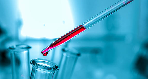 istock Pipette adding fluid to one of several test tubes .medical 503948772