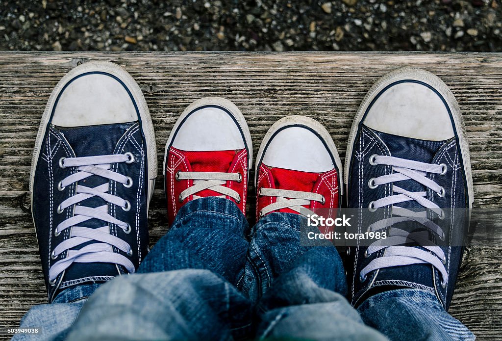 Men's and children's branded shoes together. Shoe Stock Photo