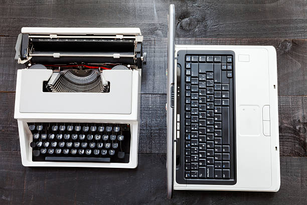 istock Typewriter and computer laptop on wooden background retro 503950982