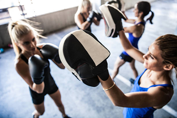 Women sport team boxing outdoor Group of women sport team boxing outdoor in a parking in Australia. women boxing sport exercising stock pictures, royalty-free photos & images