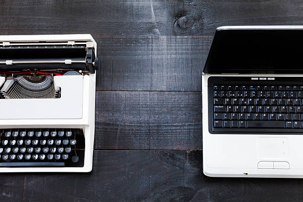 istock Typewriter and computer laptop on wooden background retro 503951310