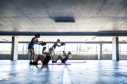 Group of women sport team boxing outdoor in a parking in Australia.