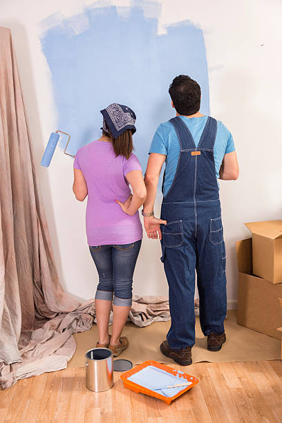 istock Construction: Latin couple. Home improvement projects. Painting a wall. 503955676
