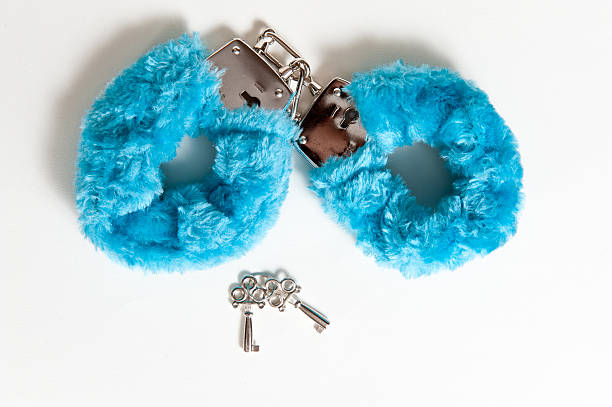 Blue fuzzy handcuffs with keys stock photo
