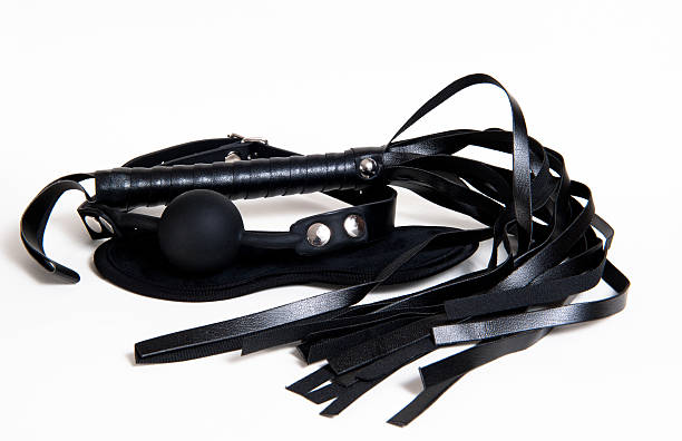 istock Black Flogger, blindfold and ball gag on white background 503956448