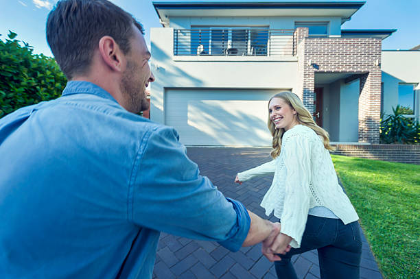 istock Couple joyfully running into their new home. 503956540