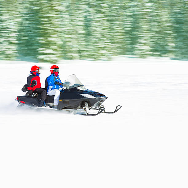istock Woman and kid on snowmobile 503957270