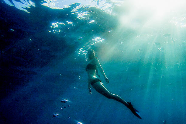 istock Girl ascending towards the surface underwater 503958956