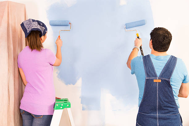 istock Construction: Latin couple. Home improvement projects. Painting a wall. 503959266