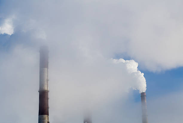istock Power plant pipes smoking in the sky 503960314