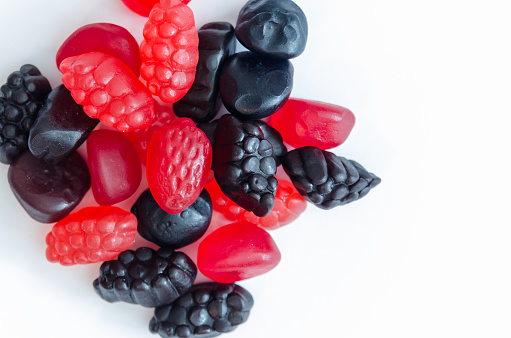 Berry shaped gummy snacks on a white background