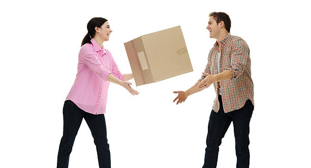 istock Happy couple  throwing / passing the box 503978442